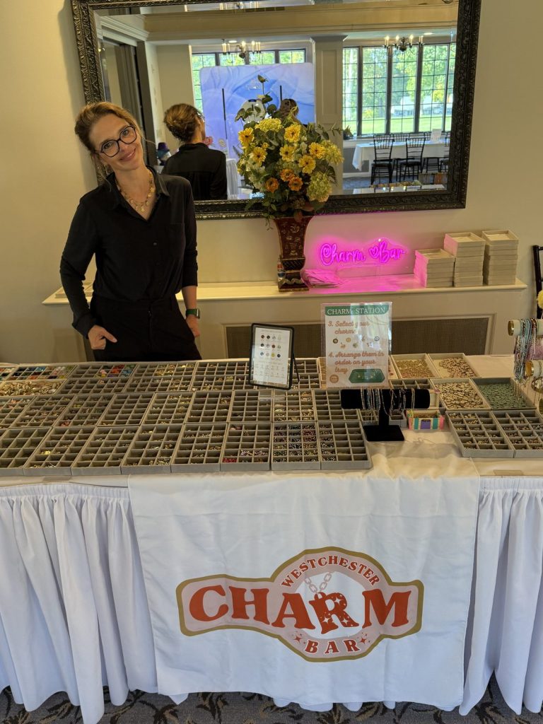 Westchester Charm Bar table with a neon sign and charm trays