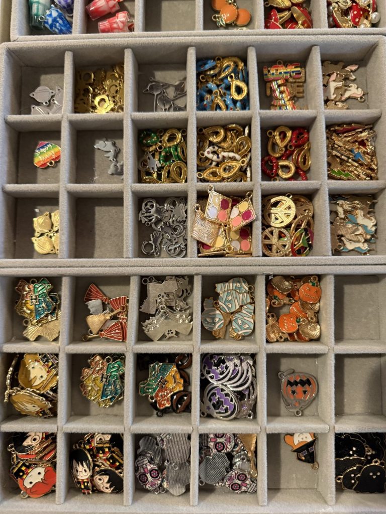 Trays of enamel charms in every color