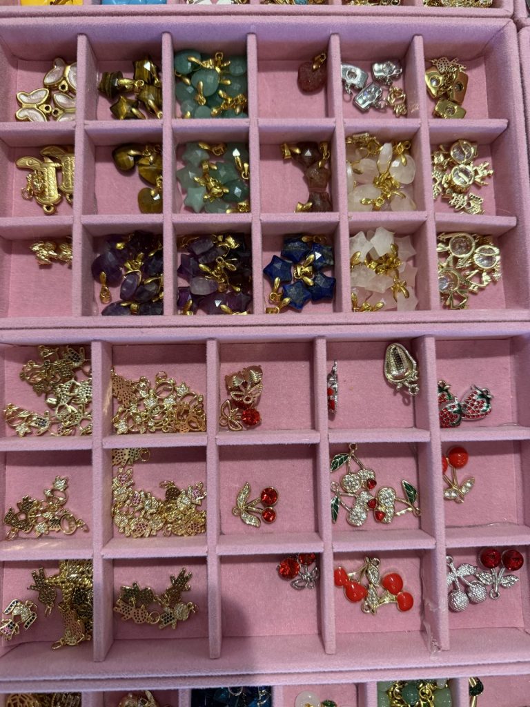 Flower and butterfly charms in pink trays