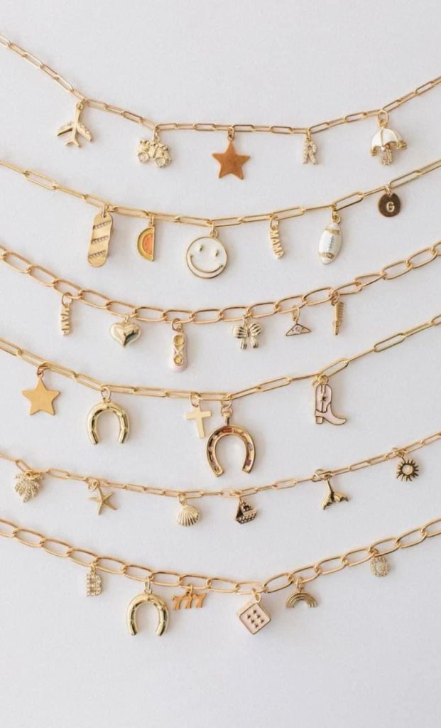 Gold charm necklaces in a row