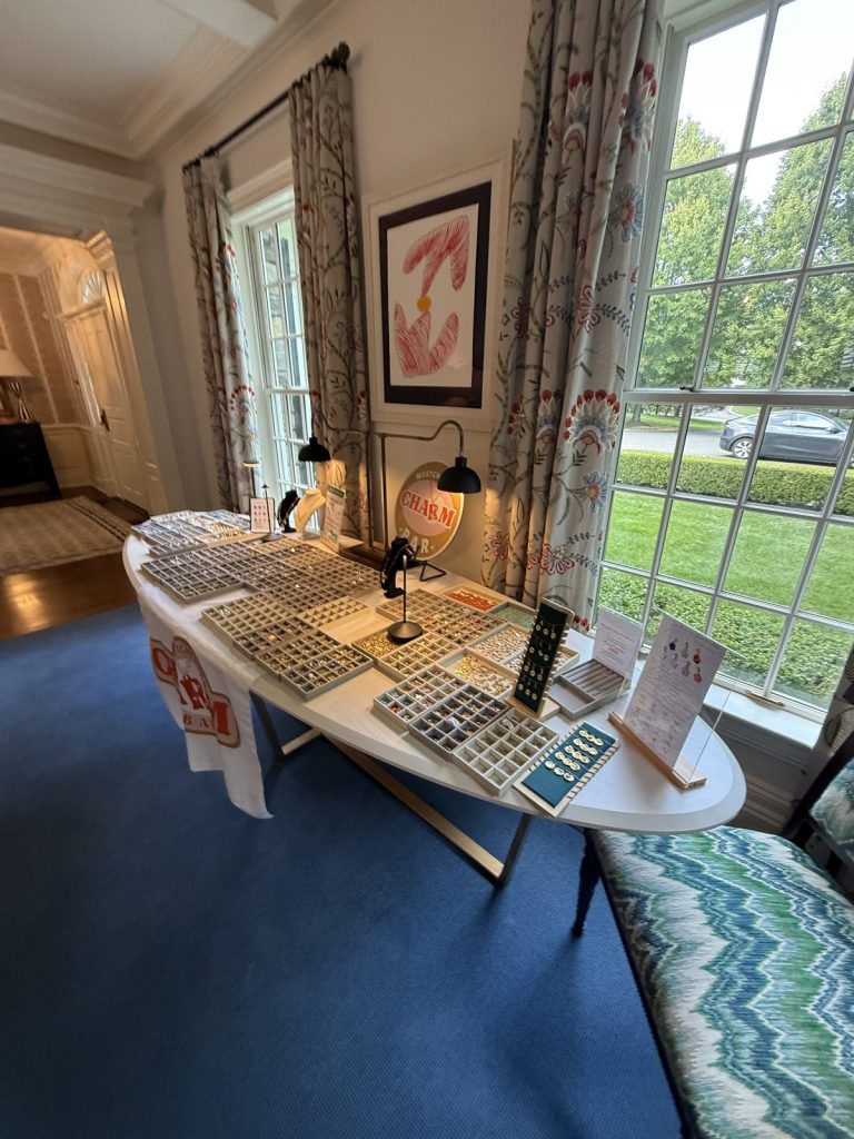 Mobile Charm Bar on an oval table in a sunny room with garden views