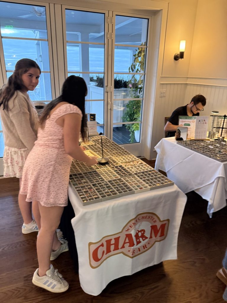 Teens picking charms at an event by the water