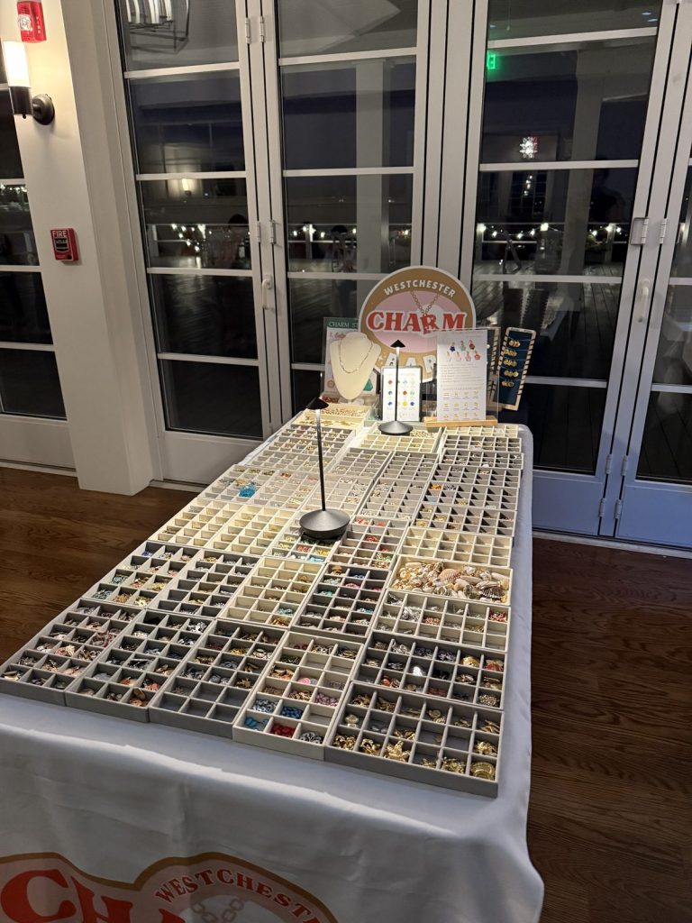 Mobile Charm Bar set up in the evening with the water behind it