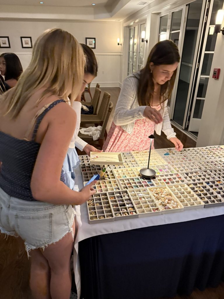 Girls choosing charms at an evening event