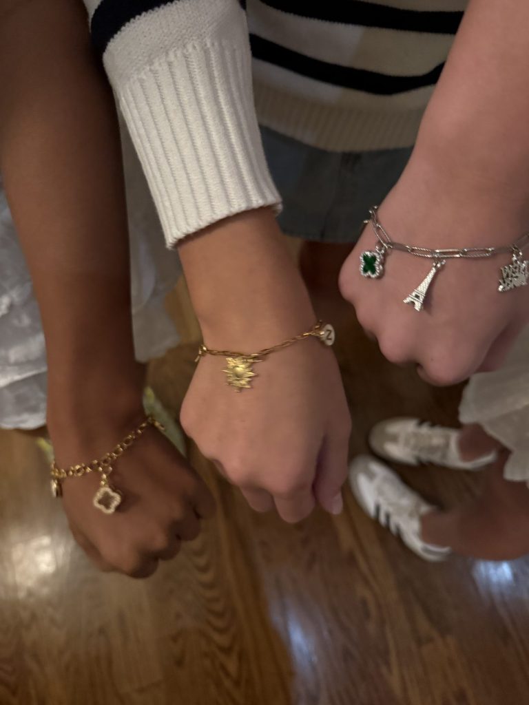Friends wearing their new charm bracelets