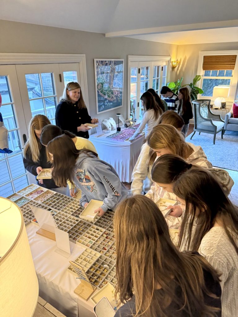 Kids crowded around the charm table at a birthday party