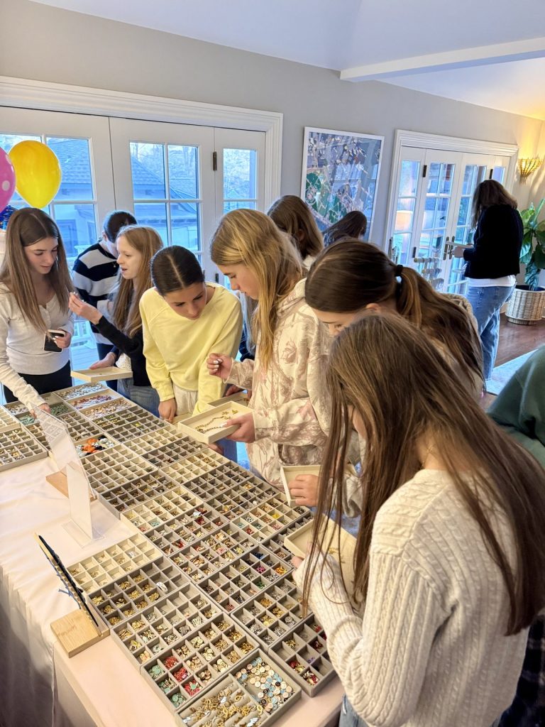 Teens choosing charms at a party with balloons