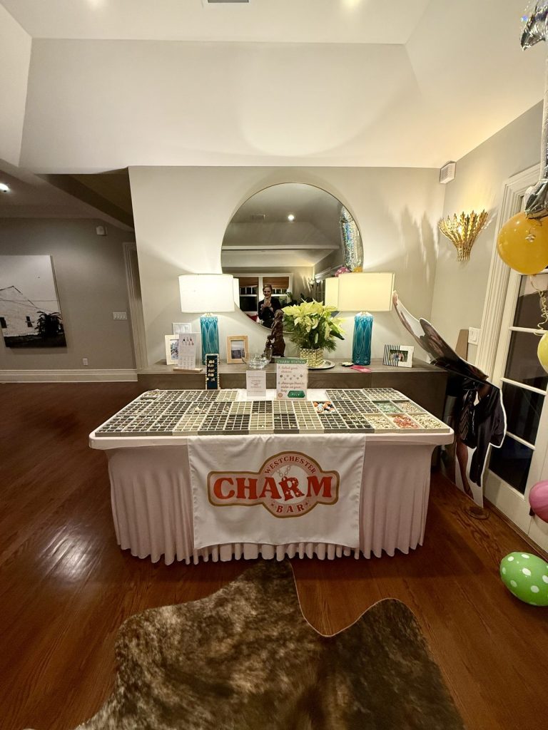 The Charm Bar set up in a hallway with the branded tablecloth
