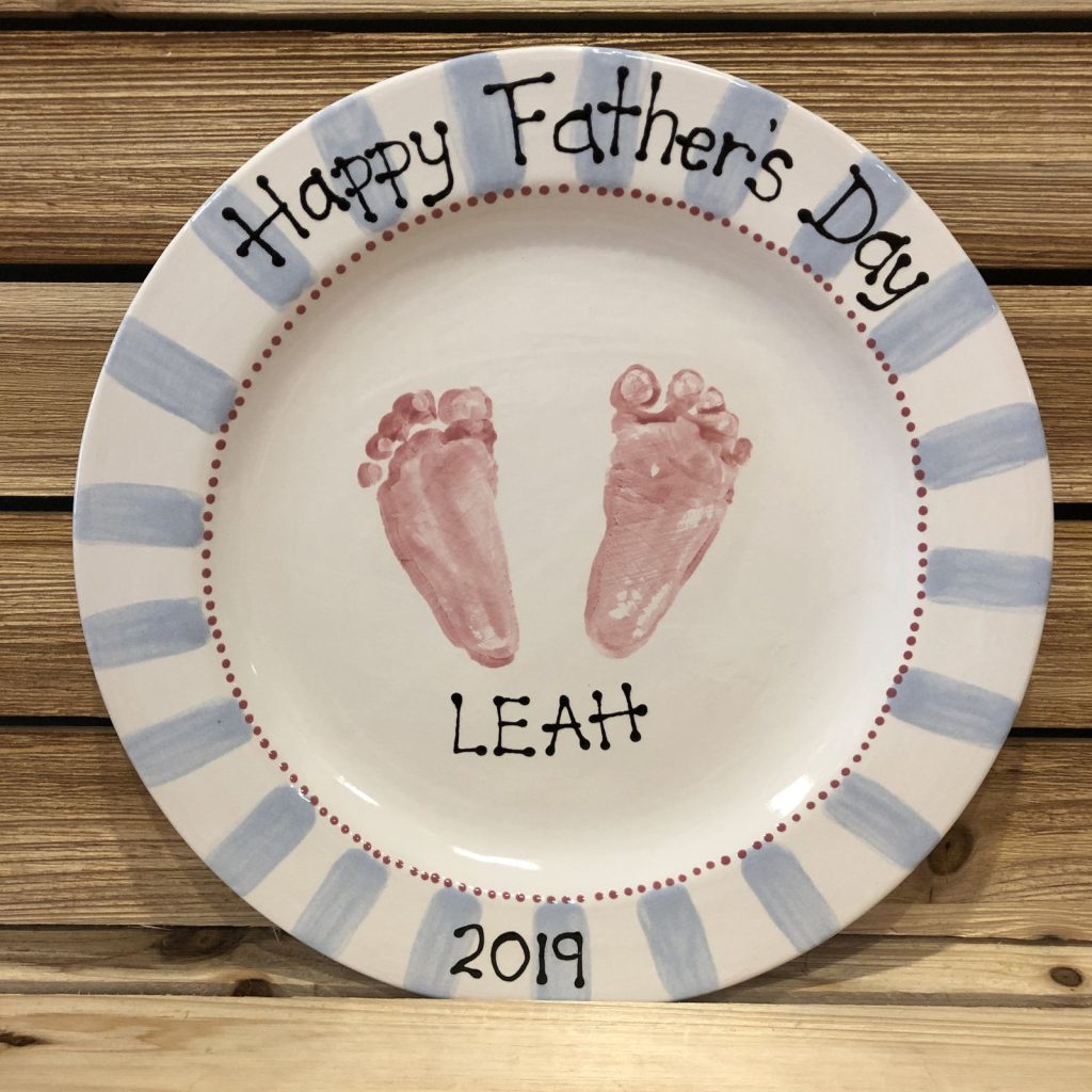 Round Happy Father's Day plate with pink baby footprints and blue striped rim