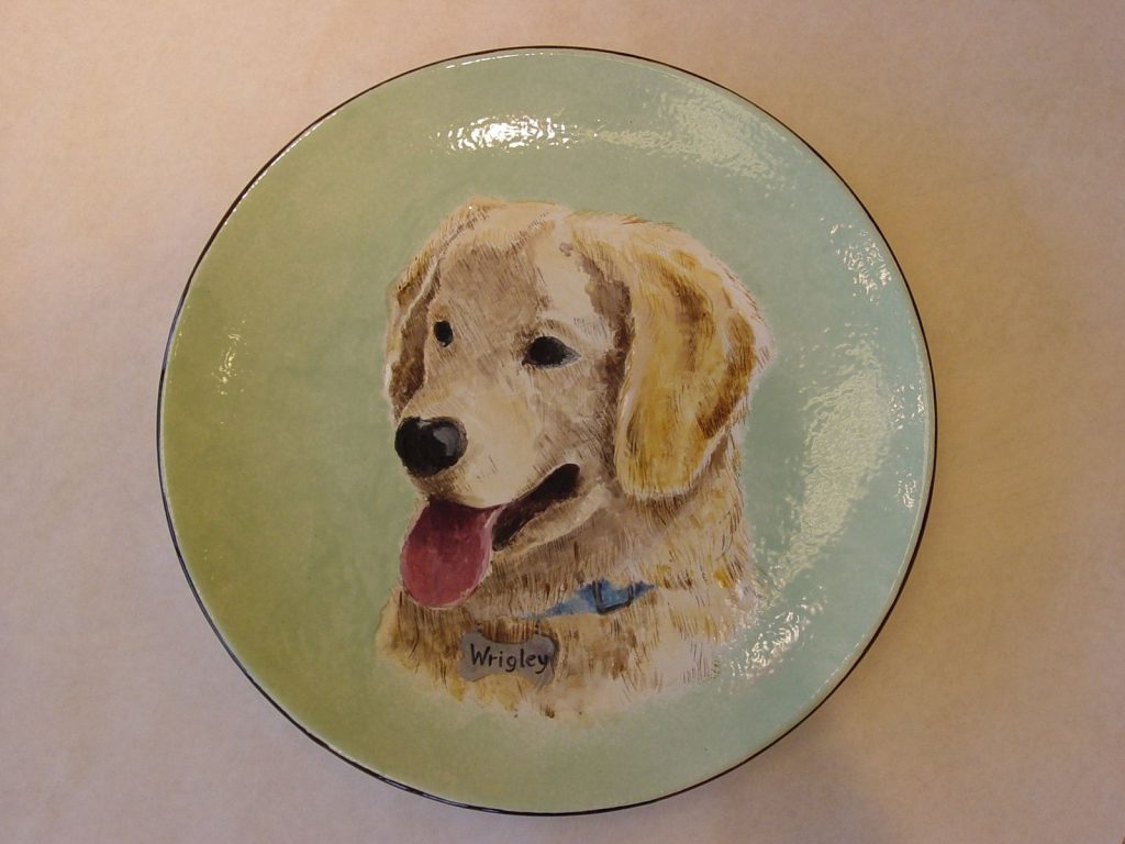 Hand-painted round plate portrait of a golden retriever with blue collar on mint green