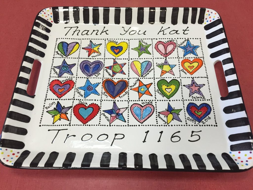 Black-and-white striped handled tray with a grid of colorful fingerprint hearts and stars, Scout troop thank-you gift