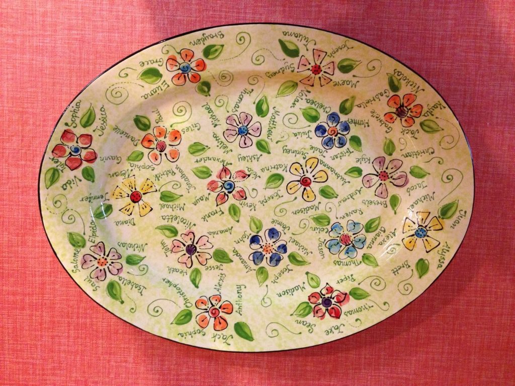 Oval class platter covered in hand-painted flowers and leaves with each student's name