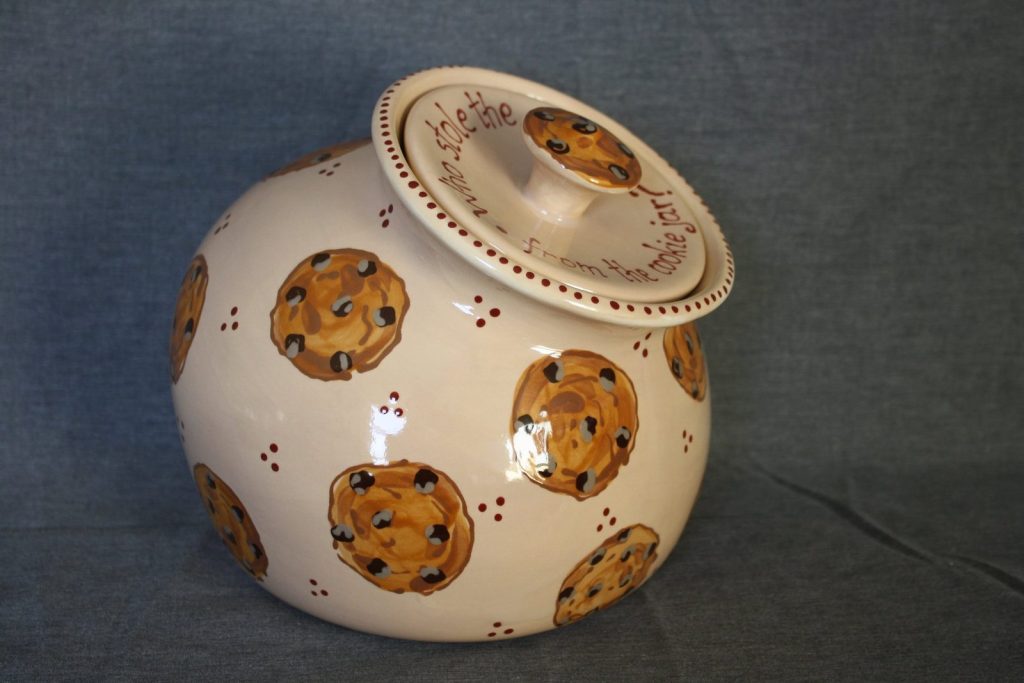 Hand-painted lidded cookie jar with chocolate chip cookies and red dots on cream