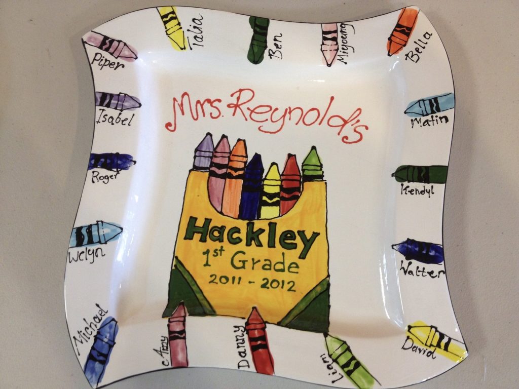Hand-painted wavy square platter for a Hackley 1st grade class with a crayon box and named crayons on the rim