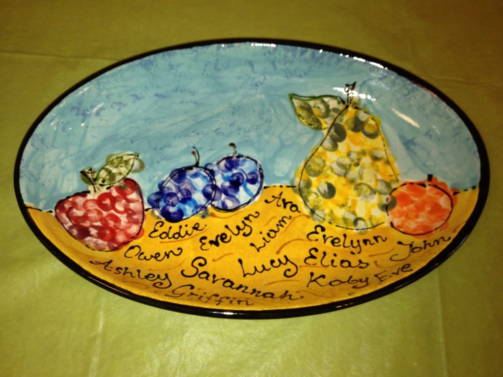 Hand-painted oval platter of fingerprint fruit, a strawberry, blueberries, pear and orange, with children's names