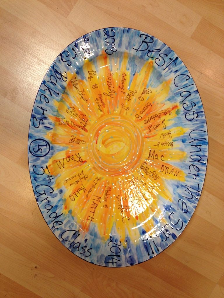 Hand-painted oval platter with a bright fingerprint sun and children's names on a blue rim