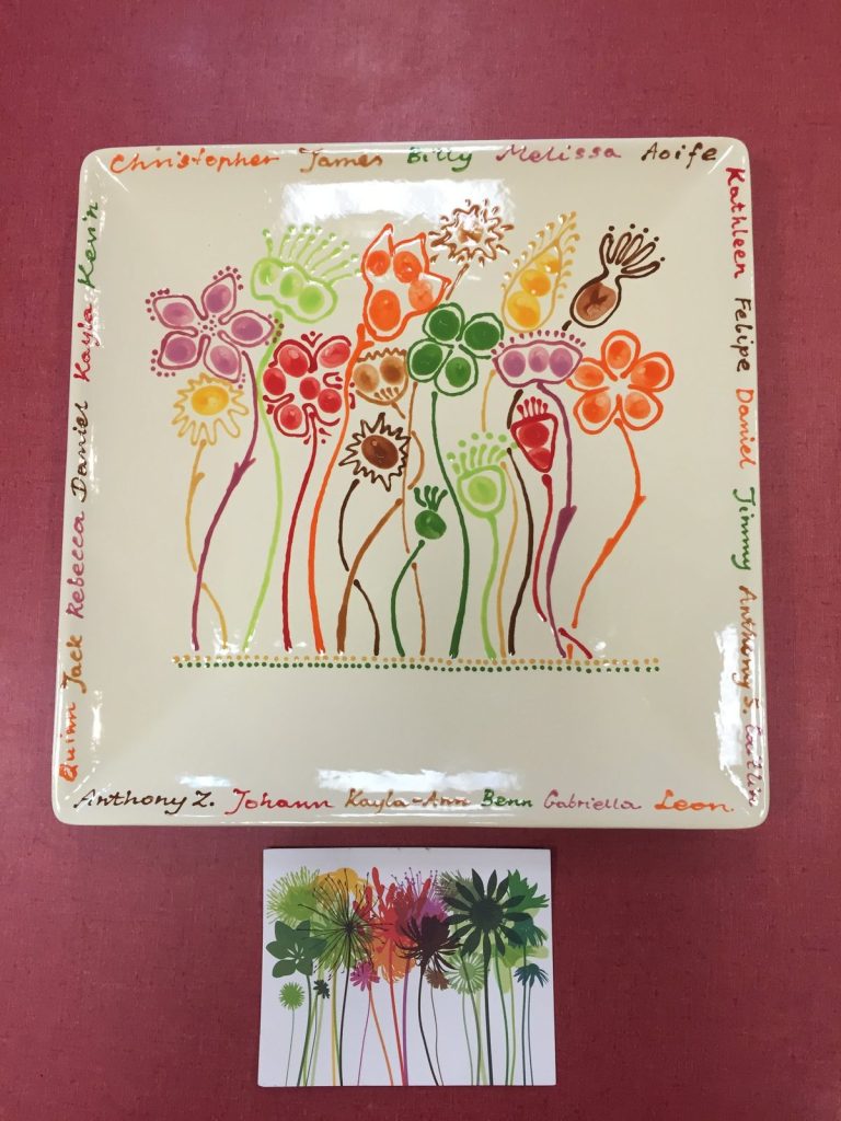 Hand-painted square platter of rainbow fingerprint flowers with children's names, shown with its design card