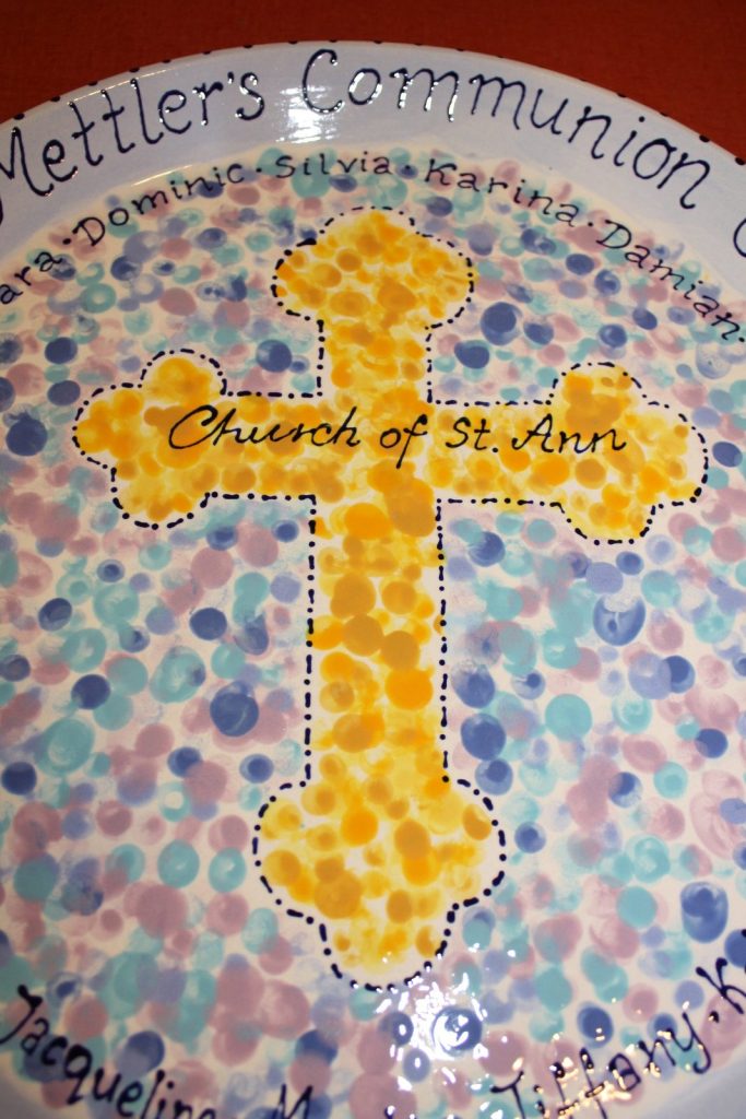 Hand-painted communion platter with a yellow fingerprint cross, "Church of St. Ann" and pastel dots