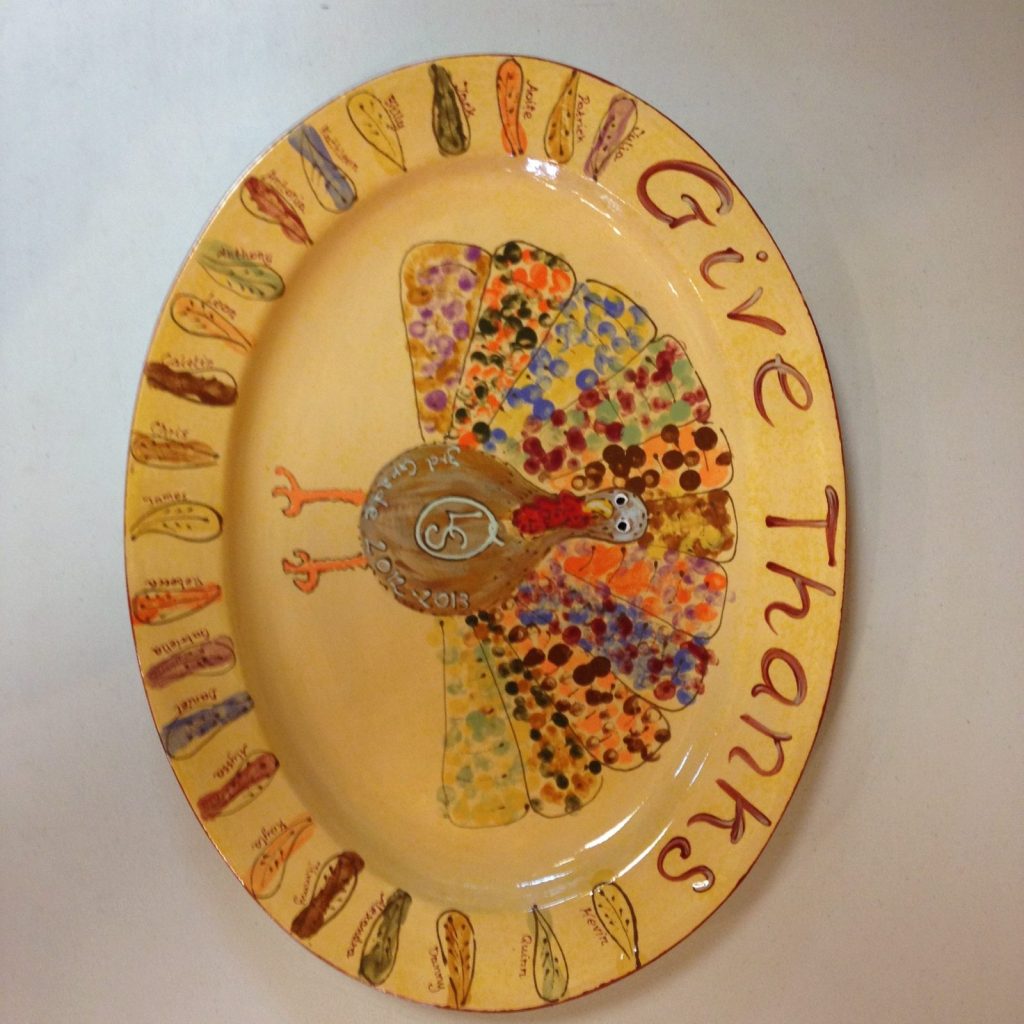 Hand-painted oval "Give Thanks" platter with a fingerprint turkey and a feather border