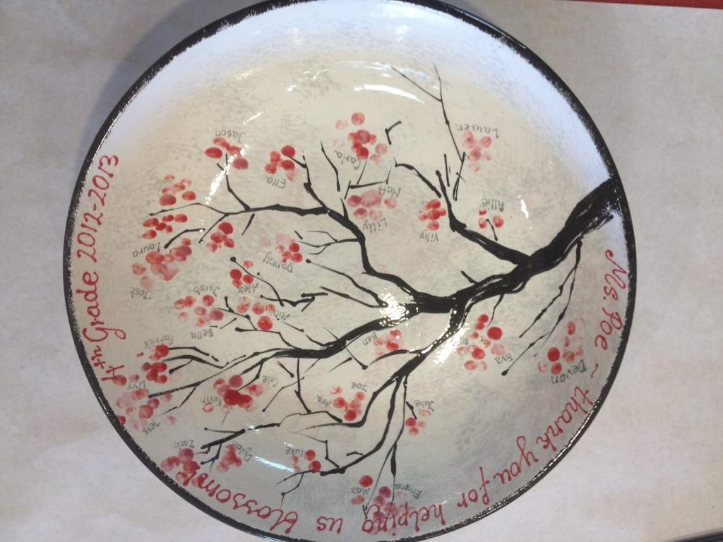Hand-painted bowl of a black branch with red fingerprint cherry blossoms and a class thank-you