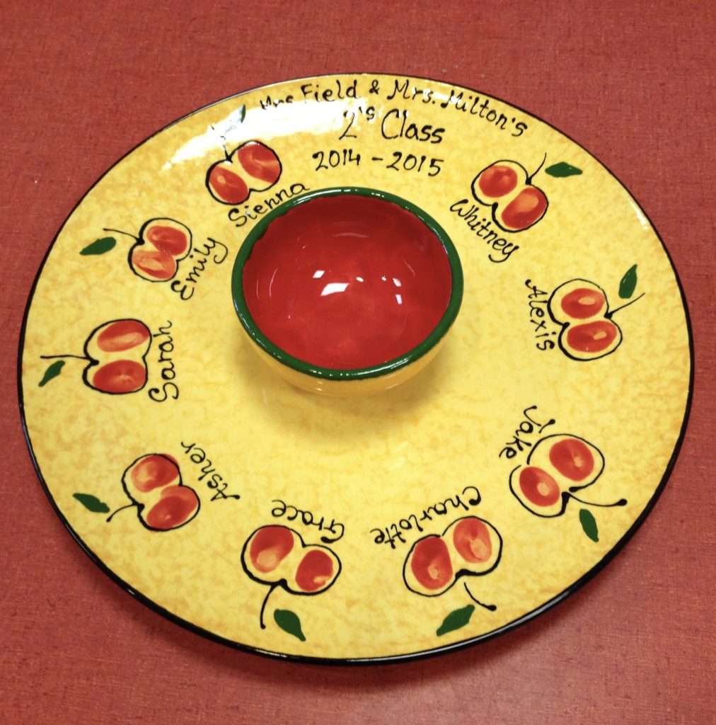 Hand-painted yellow chip and dip platter with fingerprint apples and names from a 2014–2015 class