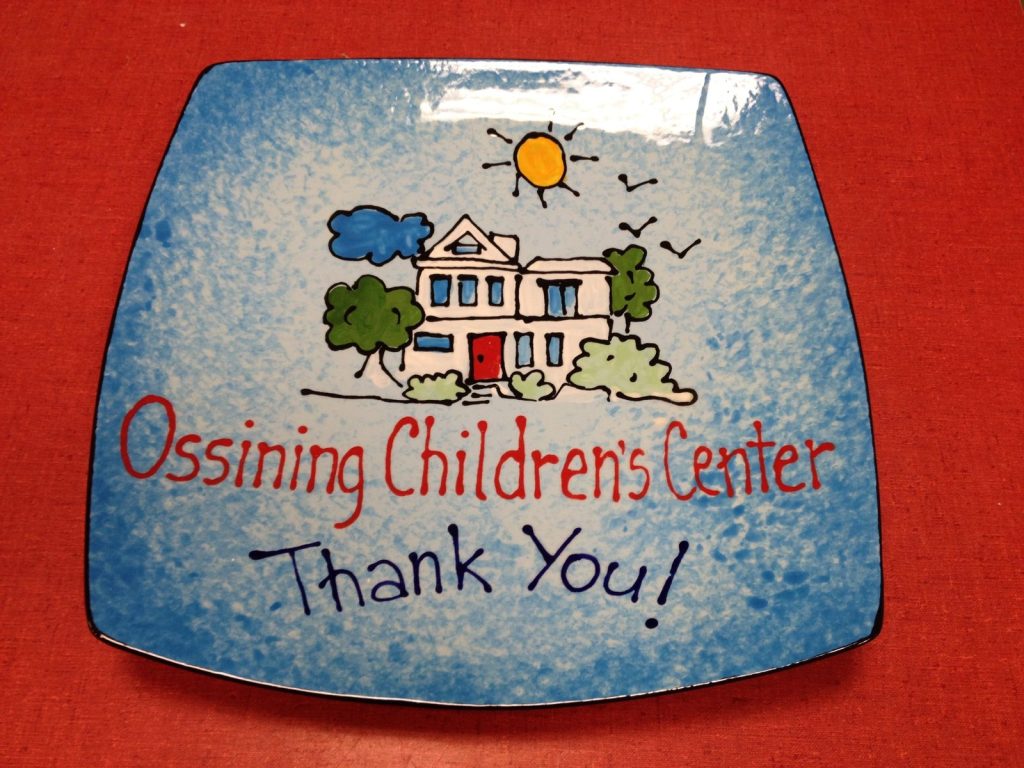 Hand-painted square blue plate with a schoolhouse and "Ossining Children's Center Thank You!"