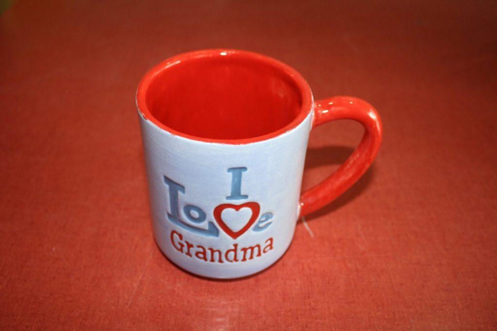 Hand-painted white mug reading I Love Grandma with a red heart and red interior