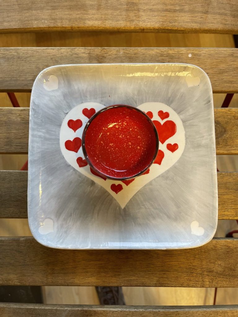 Hand-painted square gray dish with a heart of tiny red hearts around a glossy red center