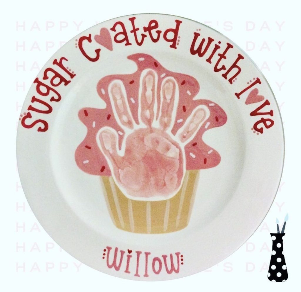 Hand-painted plate reading Sugar Coated With Love with a pink handprint cupcake