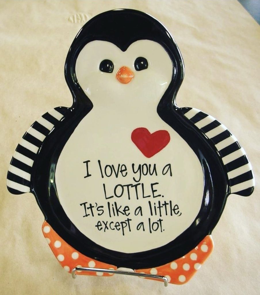 Hand-painted penguin-shaped plate reading I love you a LOTTLE with a red heart and striped flippers