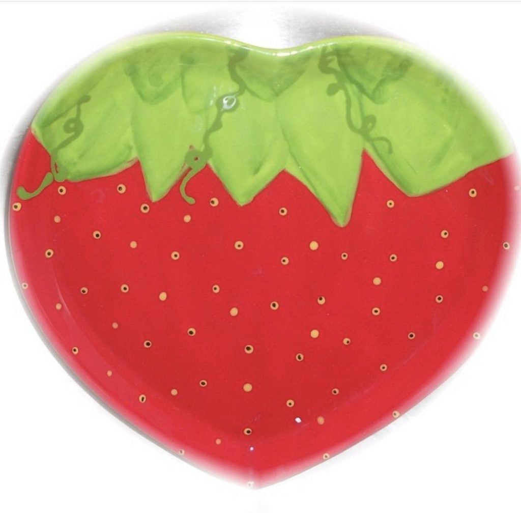 Hand-painted heart-shaped strawberry dish in glossy red with green leaves and gold seed dots