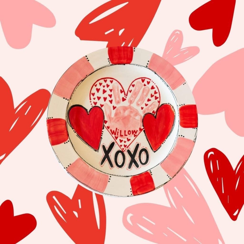 Hand-painted plate with red hearts, XOXO lettering, and a red and pink striped rim