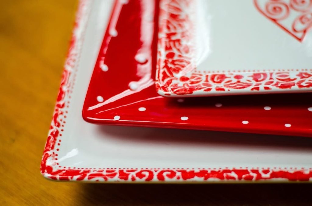 Hand-painted stacked square plates in red and white with polka dots and lace-pattern borders